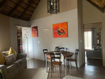 a living room with a table and a couch at Zebula - African Dream B - Pax 6 in Warmbaths