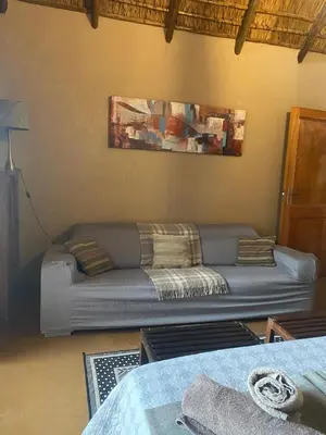 a living room with a couch in the corner at Zebula - African Dream B - Pax 6 in Warmbaths