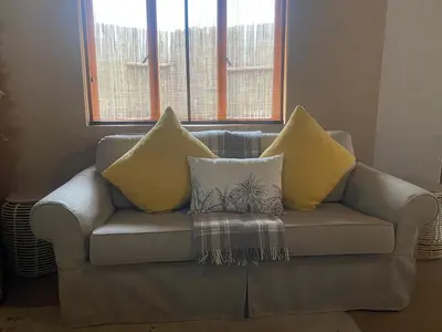 a couch with pillows on it in a living room at Zebula - African Dream B - Pax 6 in Warmbaths