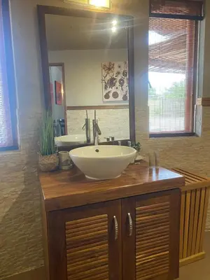 a bathroom with a sink and a large mirror at Zebula - African Dream B - Pax 6 in Warmbaths