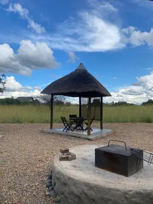 a pavilion with a bench and a table and a grill at Zebula - African Dream B - Pax 6 in Warmbaths