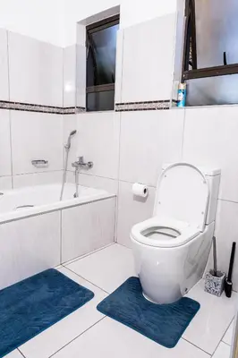 a bathroom with a toilet and a tub and a sink at Bendor Escape - Peace Privacy Power in Polokwane