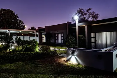 a house lit up at night with a street light at Bendor Escape - Peace Privacy Power in Polokwane