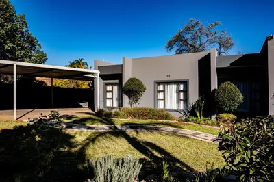 a large white house with a yard at Bendor Escape - Peace Privacy Power in Polokwane