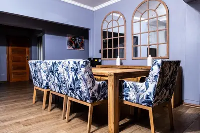 a dining room with a wooden table and chairs at Bendor Escape - Peace Privacy Power in Polokwane