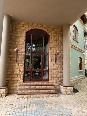 a brick building with a glass door on it at Natures View in Pretoria