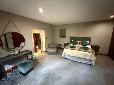 a bedroom with a bed and a large mirror at Natures View in Pretoria