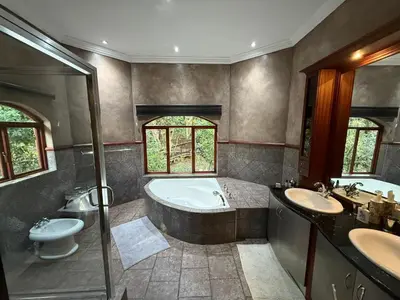 a bathroom with a tub and a toilet and a sink at Natures View in Pretoria