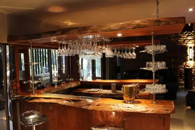 a bar with wine glasses hanging above it at Natures View in Pretoria