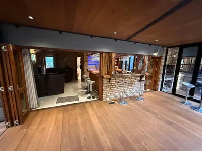 a living room with wood floors and a fireplace at Natures View in Pretoria