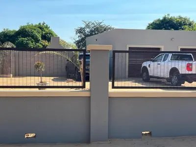 a white truck parked in front of a building at The Village Haven Lodge