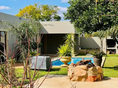 a house with a swimming pool in a yard at The Village Haven Lodge