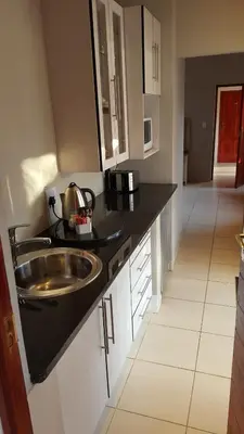 a kitchen with a sink and a counter top at Casa Bianca Guest Lodge in Hartbeespoort