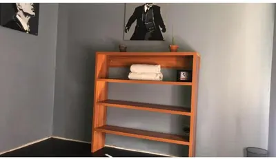 a wooden book shelf with towels on it at The Chardonnay Inn in Centurion