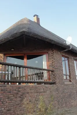 a window of a brick building with a balcony at Bushtime at Mabula in Bela-Bela