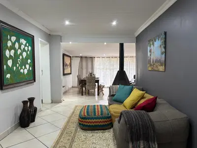 a living room with a couch and a table at DullVino Wellington House in Dullstroom