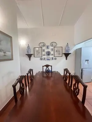 a room with a long table with chairs and plates on the wall at Palm House Accommodation White River in White River