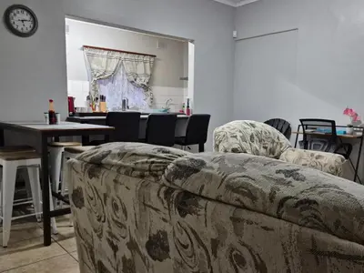 a living room with a couch and a table at 5 On Park in Phalaborwa