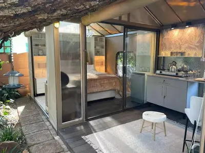 a large glass house with a bed in it at African Paradise - Garden Glamping - Outdoor Shower in Benoni