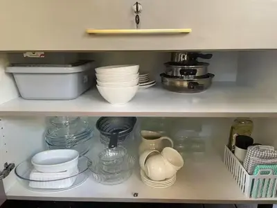 a shelf with plates and bowls and other dishes at African Paradise - Garden Glamping - Outdoor Shower in Benoni