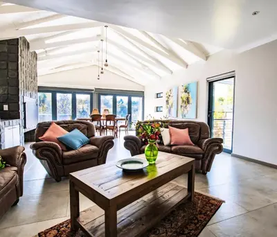 a living room with couches and a table at Rusgerus in Pretoria