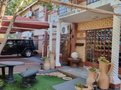 a patio with a table and a building at Wonder House Lodge in Mokopane