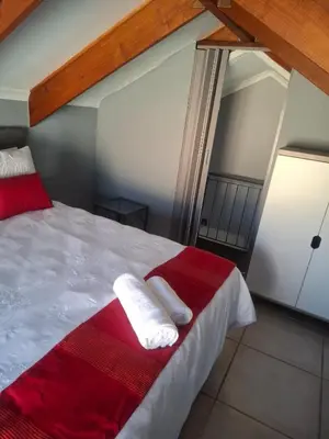 a bedroom with a bed with two towels on it at 77 Pendleberry Grove in Warmbaths