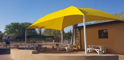 a large yellow umbrella in front of a building at 77 Pendleberry Grove in Warmbaths