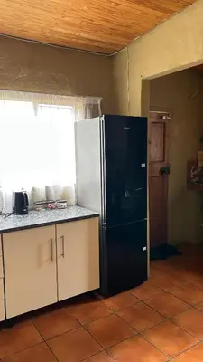 a kitchen with a black and white refrigerator at Garden Unit in Pretoria