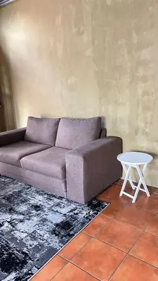 a living room with a couch and a table at Garden Unit in Pretoria