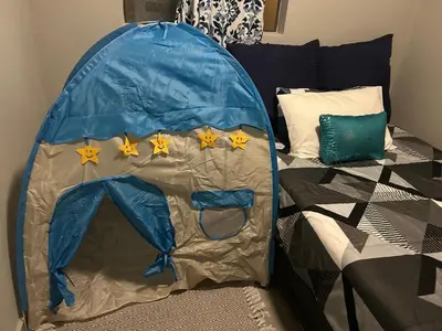 a bed with a blue tent with stars on it at Double Bed in the Capital City in Pretoria