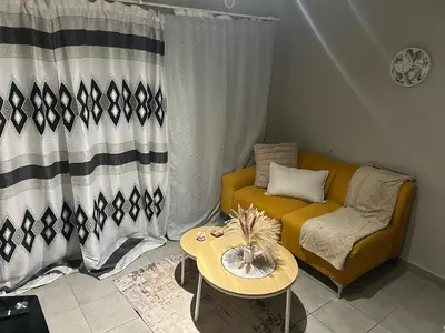a living room with a couch and a table at Double Bed in the Capital City in Pretoria