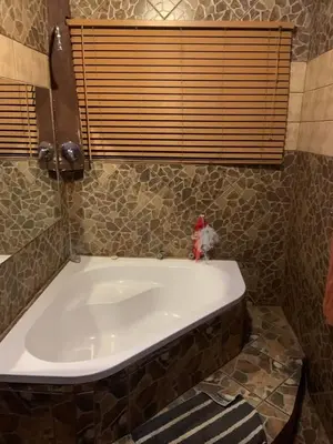 a large bath tub in a bathroom with a window at Epizone in Mokopane