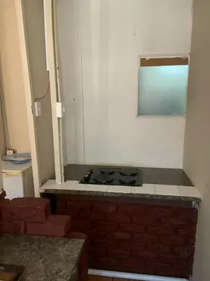 a kitchen with a stove top in a room at Epizone in Mokopane