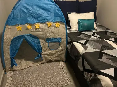 a bed with a blue tent with stars on it at Two Bedrooms in the Capital City in Pretoria