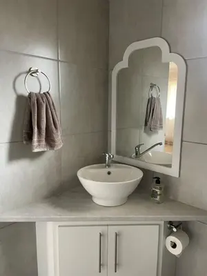 a bathroom with a sink and a mirror and towels at Pecan Stay Bed and Breakfast in Rayton