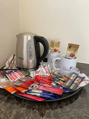 a tray with a tea pot and coffee cups and magazines at Pecan Stay Bed and Breakfast in Rayton