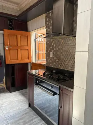 a kitchen with a stove and a counter top at Lulu's guest house in Nelspruit