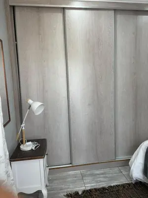 a bedroom with a sliding glass door at Lulu's guest house in Nelspruit