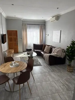 a living room with a couch and a table at Lulu's guest house in Nelspruit