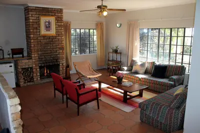 a living room with a couch and a fireplace at Ndlovu 41 inside the Dinokeng Big 5 Game Reserve in Dinokeng Game Reserve