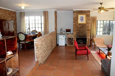 a living room with a couch and a fireplace at Ndlovu 41 inside the Dinokeng Big 5 Game Reserve in Dinokeng Game Reserve