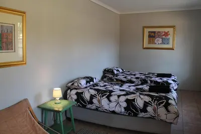 a bedroom with a bed and a table with a lamp at Ndlovu 41 inside the Dinokeng Big 5 Game Reserve in Dinokeng Game Reserve