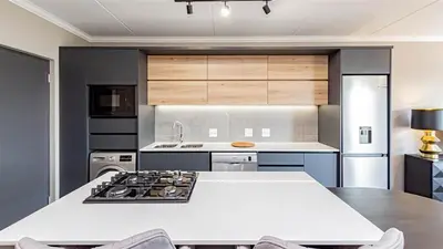 a kitchen with a stove and a white counter top at Aesthetic modern apartment in Midrand