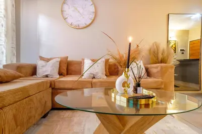 a living room with a glass table and a couch at The Local house in Midrand