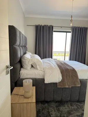 a bedroom with a large bed and a window at The Dream Stay At The Blyde - Suite 1 in Pretoria