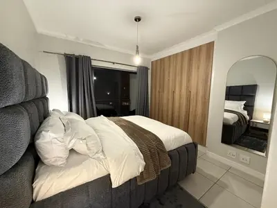 a bedroom with a bed and a large mirror at The Dream Stay At The Blyde - Suite 1 in Pretoria