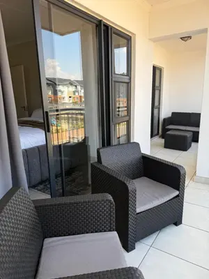 a living room with two chairs and a bed at The Dream Stay At The Blyde - Suite 1 in Pretoria