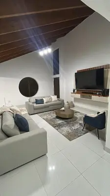 a living room with two couches and a flat screen tv at VillaDelux in Pretoria