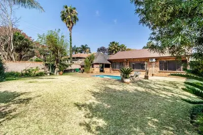 a house with a yard with a swimming pool at VillaDelux in Pretoria